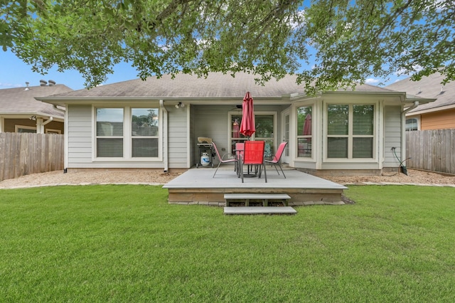 rear view of house featuring a wooden deck and outdoor dining space