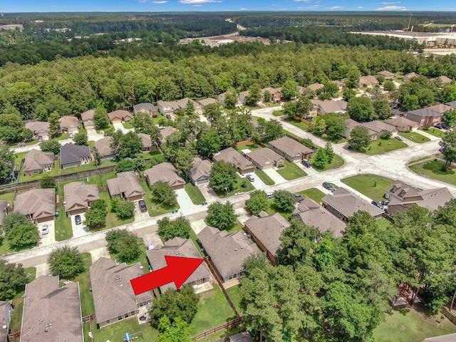aerial overview of property's location with nearby suburban area and a forest