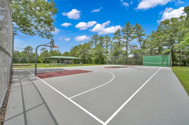 view of basketball court with community basketball court and fence