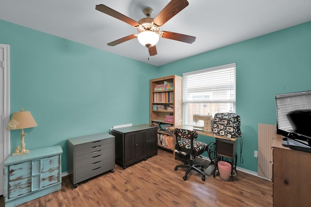 office area with wood finished floors, a ceiling fan, and baseboards