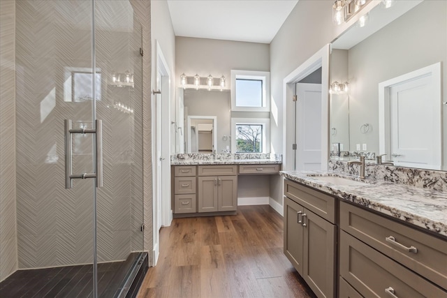 3104 Eunice St, Houston, TX 77009 - full bathroom with a shower stall, wood finished floors, and two vanities
