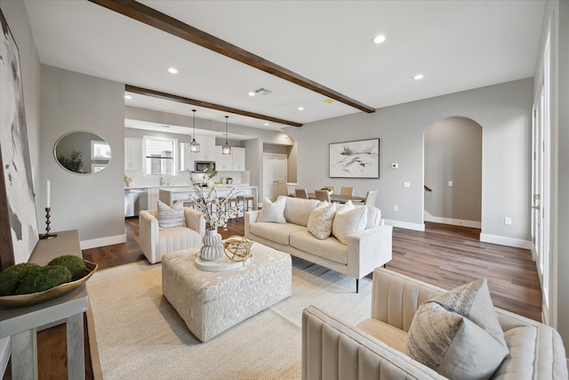 3104 Eunice St, Houston, TX 77009 - living room with arched walkways, recessed lighting, light wood-style flooring, beam ceiling, and baseboards