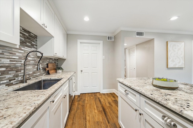 12709 Huntingwick Dr Unit 167, Houston, TX 77024 - kitchen with a sink, crown molding, dark wood-type flooring, backsplash, and white cabinets