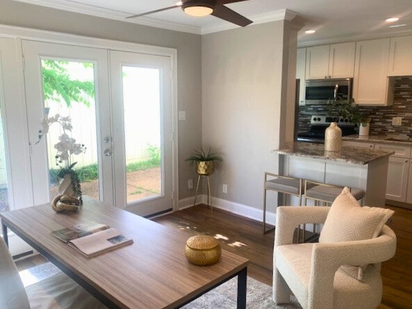 12709 Huntingwick Dr Unit 167, Houston, TX 77024 - living room featuring crown molding, ceiling fan, baseboards, dark wood finished floors, and french doors