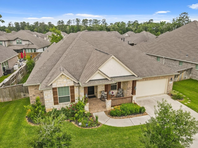 23440 Yaupon Hills Dr, New Caney, TX 77357 - view of front of property with covered porch, stone siding, concrete driveway, an attached garage, and roof with shingles