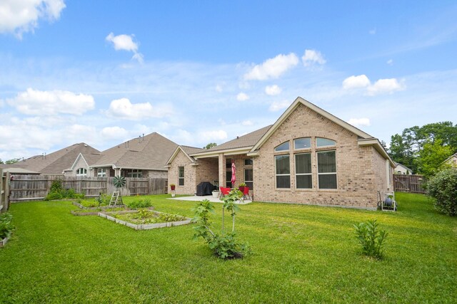 23440 Yaupon Hills Dr, New Caney, TX 77357 - back of property featuring brick siding and a patio area