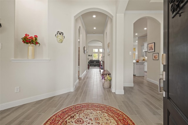 23440 Yaupon Hills Dr, New Caney, TX 77357 - entrance foyer featuring arched walkways, light wood-style flooring, baseboards, ornamental molding, and recessed lighting