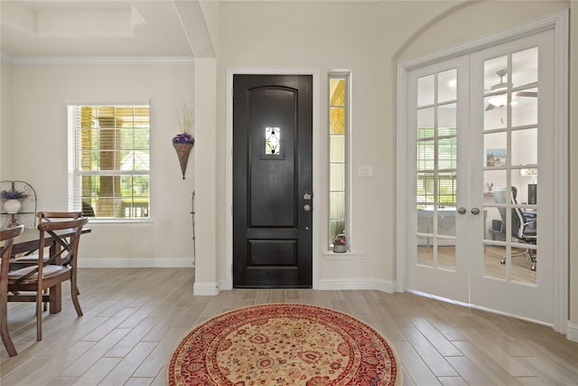23440 Yaupon Hills Dr, New Caney, TX 77357 - foyer with light wood finished floors, plenty of natural light, baseboards, and crown molding
