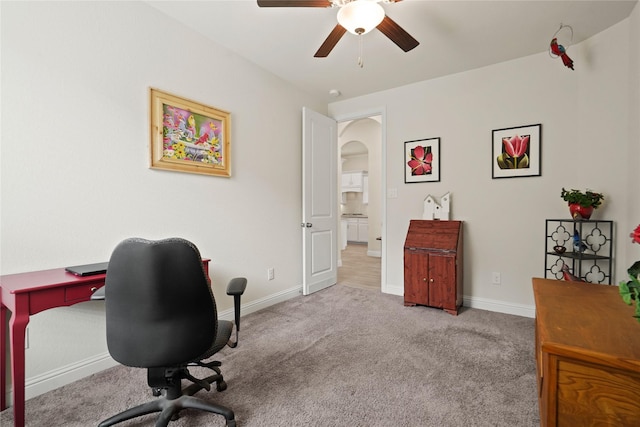 23440 Yaupon Hills Dr, New Caney, TX 77357 - office area featuring a ceiling fan, arched walkways, carpet flooring, and baseboards