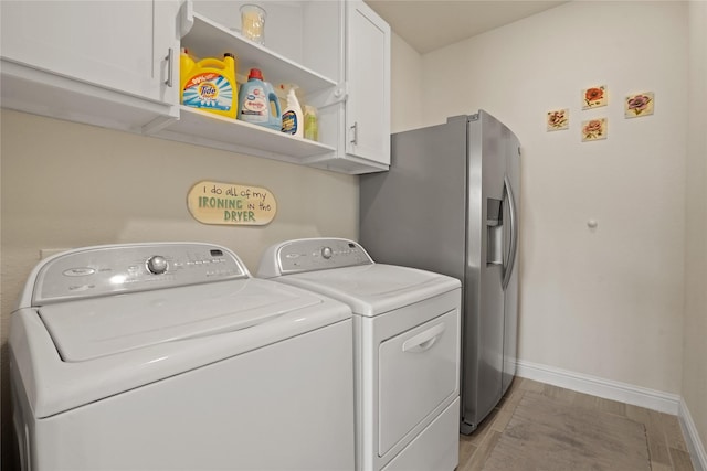 23440 Yaupon Hills Dr, New Caney, TX 77357 - laundry room with cabinet space, washer and dryer, and baseboards