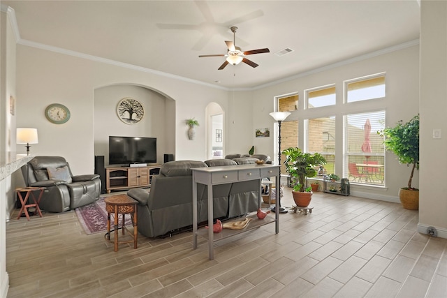 23440 Yaupon Hills Dr, New Caney, TX 77357 - living area with crown molding, arched walkways, ceiling fan, baseboards, and wood finished floors