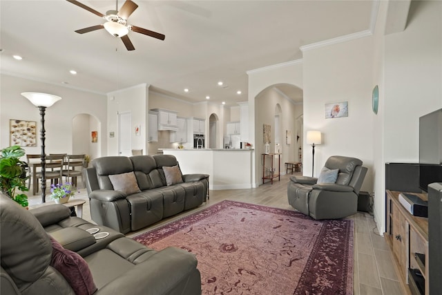 23440 Yaupon Hills Dr, New Caney, TX 77357 - living area with arched walkways, ceiling fan, crown molding, recessed lighting, and light wood-style floors