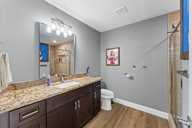5511 Queensloch Dr, Houston, TX 77096 - full bath featuring toilet, a stall shower, vanity, wood finished floors, and baseboards