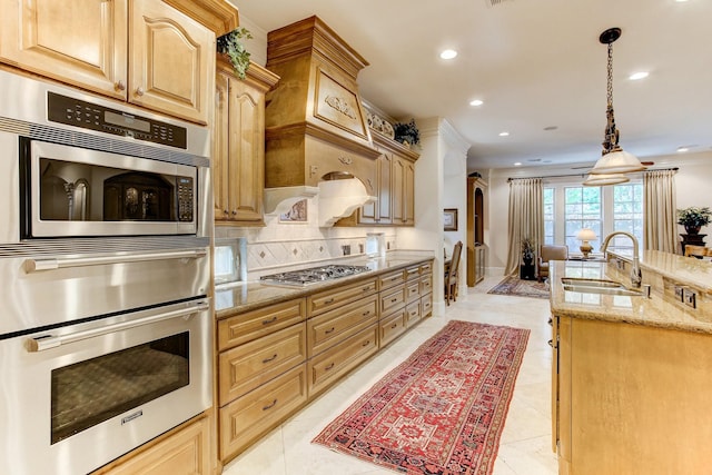 256 S Post Oak Ln, Houston, TX 77056 - kitchen featuring a sink, appliances with stainless steel finishes, decorative backsplash, recessed lighting, and light stone countertops