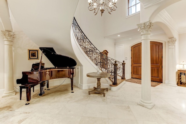 256 S Post Oak Ln, Houston, TX 77056 - foyer with ornate columns, arched walkways, a towering ceiling, a chandelier, and crown molding
