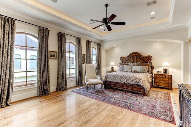 256 S Post Oak Ln, Houston, TX 77056 - bedroom featuring a tray ceiling, ornamental molding, light wood-style flooring, baseboards, and ceiling fan