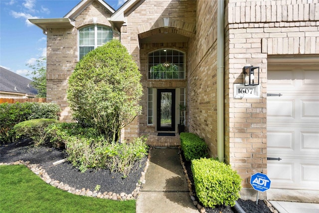 entrance to property featuring brick siding