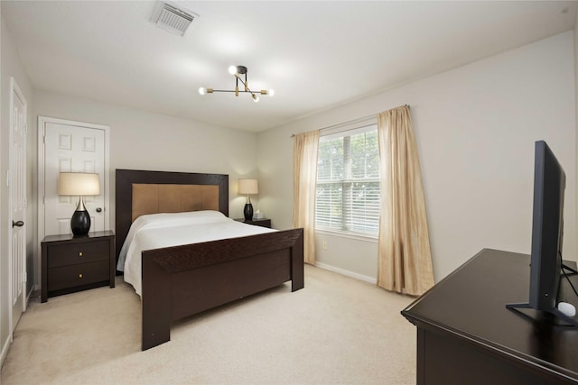 bedroom with a chandelier, light carpet, and baseboards