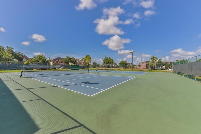 view of tennis court with fence