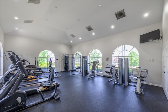 workout area featuring high vaulted ceiling, recessed lighting, and baseboards