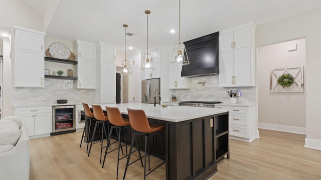 7321 Ponderosa Dr, Magnolia, TX 77354 - kitchen with wine cooler, open shelves, premium range hood, stainless steel fridge with ice dispenser, and light countertops