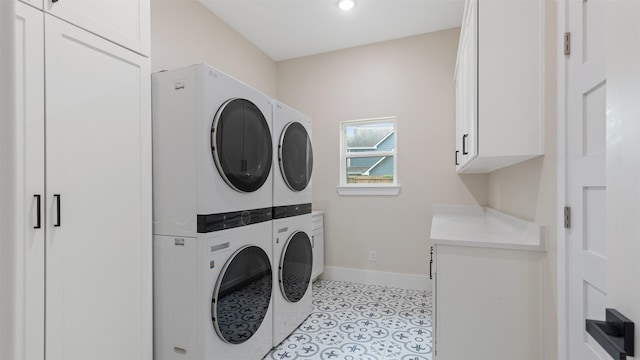 7321 Ponderosa Dr, Magnolia, TX 77354 - washroom featuring stacked washer / dryer, baseboards, and cabinet space