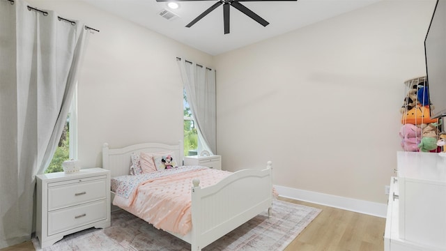 7321 Ponderosa Dr, Magnolia, TX 77354 - bedroom featuring multiple windows, light wood-type flooring, baseboards, and a ceiling fan
