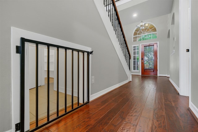 9619 Silver Birch Ct, Missouri City, TX 77459 - entryway featuring wood-type flooring, baseboards, a high ceiling, and stairway