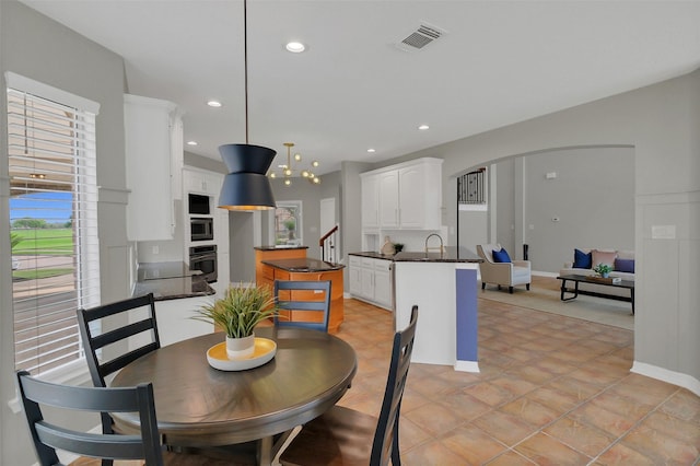 9619 Silver Birch Ct, Missouri City, TX 77459 - dining area featuring arched walkways, recessed lighting, baseboards, and stairs