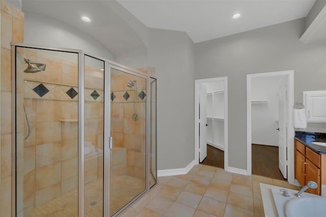 9619 Silver Birch Ct, Missouri City, TX 77459 - full bathroom featuring a stall shower, a spacious closet, vanity, a garden tub, and tile patterned flooring