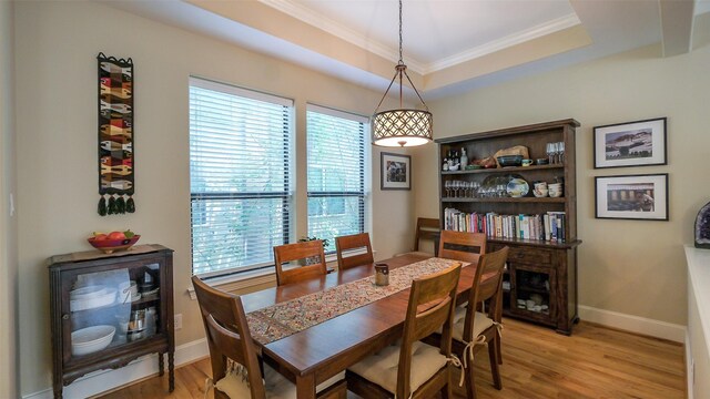 1609 W 24th St Unit B, Houston, TX 77008 - dining area featuring plenty of natural light, crown molding, light wood-style flooring, baseboards, and a raised ceiling