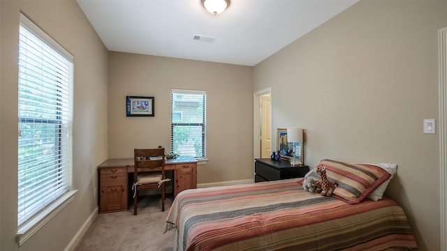 1609 W 24th St Unit B, Houston, TX 77008 - bedroom with light carpet, baseboards, and a desk