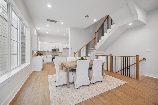 1037 17th St, Houston, TX 77008 - dining area with light wood finished floors, recessed lighting, plenty of natural light, and baseboards