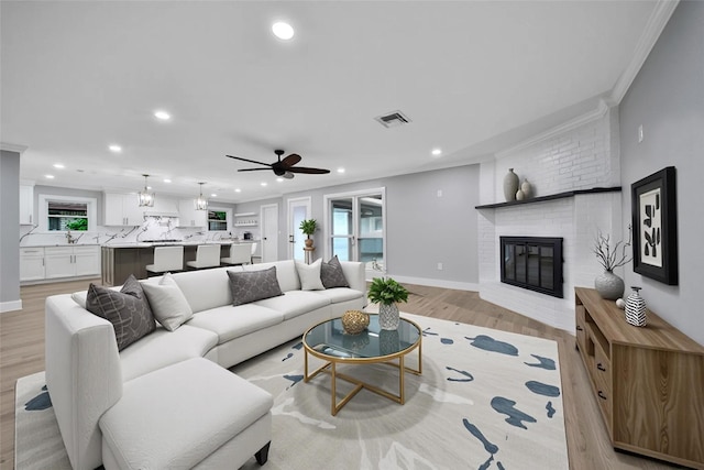 1122 Lehman St, Houston, TX 77018 - living area with recessed lighting, a fireplace, light wood-type flooring, crown molding, and ceiling fan