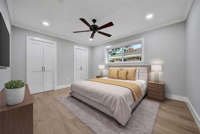 1122 Lehman St, Houston, TX 77018 - bedroom with baseboards, crown molding, recessed lighting, light wood-style floors, and two closets