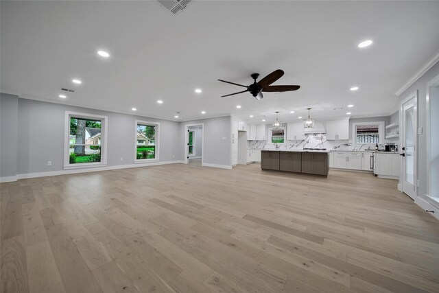 1122 Lehman St, Houston, TX 77018 - unfurnished living room featuring a ceiling fan, recessed lighting, light wood-type flooring, baseboards, and ornamental molding