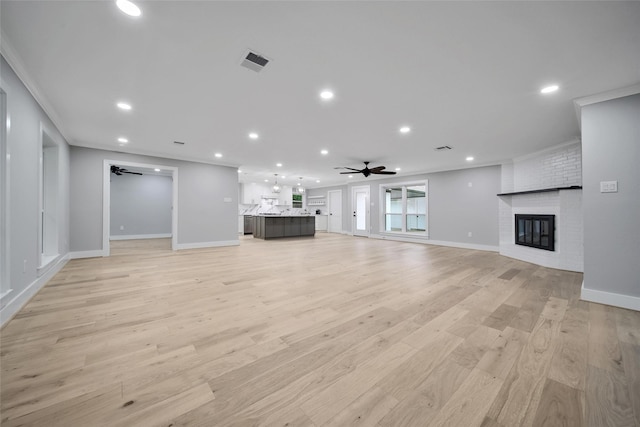 1122 Lehman St, Houston, TX 77018 - unfurnished living room with ceiling fan, a brick fireplace, baseboards, light wood finished floors, and recessed lighting