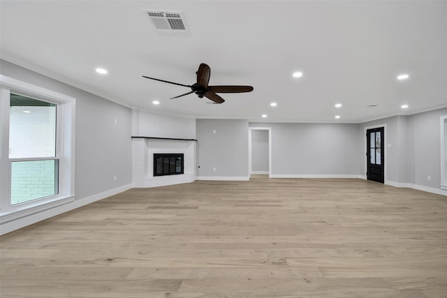 1122 Lehman St, Houston, TX 77018 - unfurnished living room featuring a ceiling fan, baseboards, recessed lighting, light wood-style floors, and a fireplace