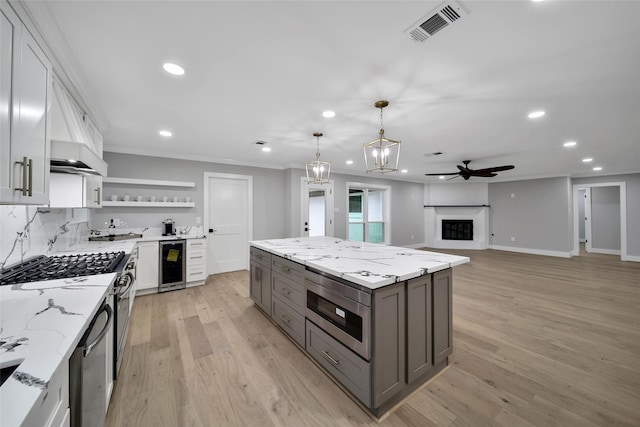 1122 Lehman St, Houston, TX 77018 - kitchen featuring wine cooler, gray cabinetry, open shelves, recessed lighting, and light wood-style flooring