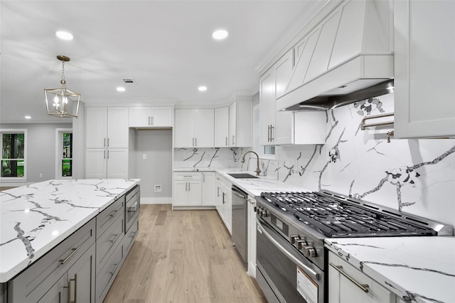 1122 Lehman St, Houston, TX 77018 - kitchen featuring stainless steel appliances, gray cabinetry, a sink, premium range hood, and recessed lighting