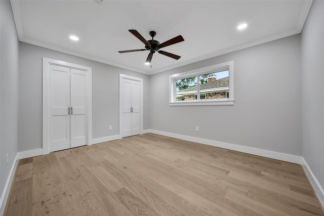 1122 Lehman St, Houston, TX 77018 - unfurnished bedroom featuring two closets, light wood-style flooring, baseboards, crown molding, and recessed lighting