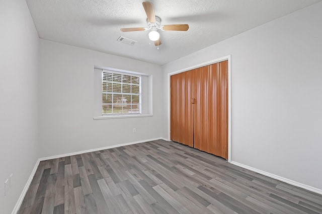 4126 Fitzwater Dr, Spring, TX 77373 - unfurnished bedroom featuring wood finished floors, baseboards, a closet, and a textured ceiling