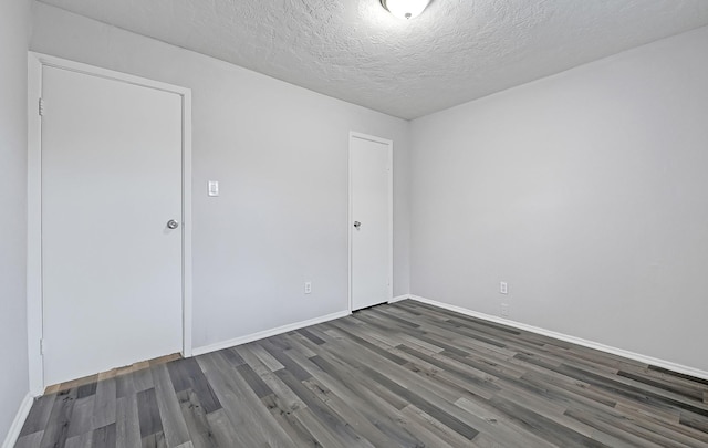 4126 Fitzwater Dr, Spring, TX 77373 - empty room with wood finished floors, baseboards, and a textured ceiling