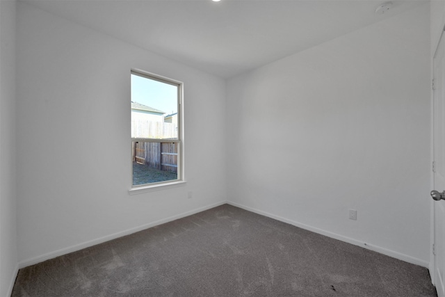 109 Chestnut Gate Dr, Conroe, TX 77378 - spare room with dark carpet, a smoke detector, and baseboards