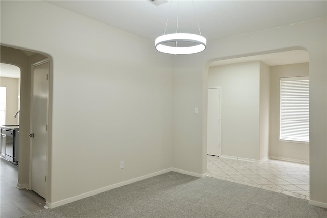23902 Spring Way Dr, Spring, TX 77373 - unfurnished room featuring arched walkways, baseboards, light colored carpet, and healthy amount of natural light