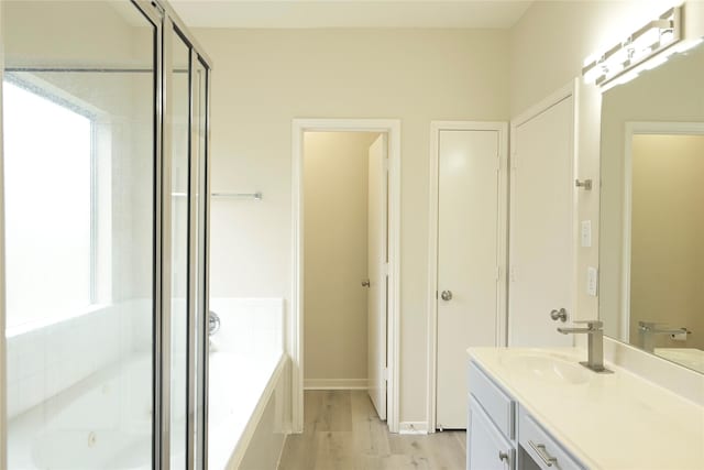 23902 Spring Way Dr, Spring, TX 77373 - bathroom with a garden tub, vanity, and wood finished floors