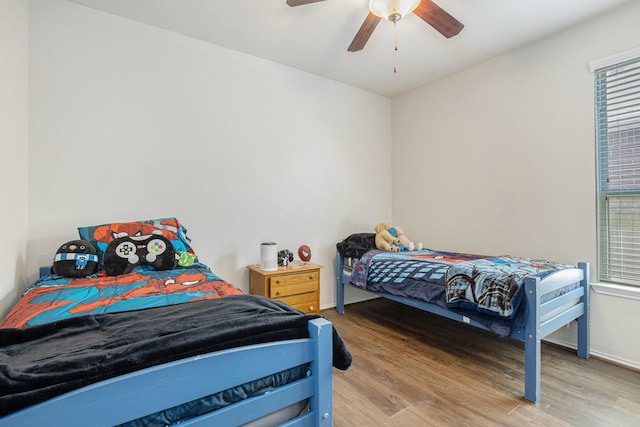 23719 Scotsman Dr, Katy, TX 77493 - bedroom featuring wood finished floors, multiple windows, baseboards, and ceiling fan