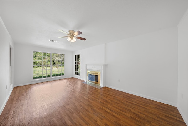 115 Old Caney Rd, Wharton, TX 77488 - unfurnished living room featuring a ceiling fan, a fireplace with flush hearth, wood finished floors, and baseboards