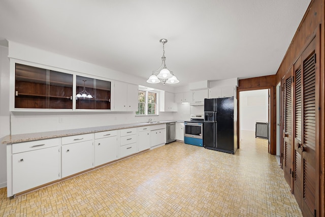 115 Old Caney Rd, Wharton, TX 77488 - kitchen featuring stainless steel appliances, a chandelier, white cabinets, and decorative light fixtures