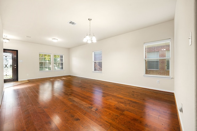506 Stream Mill Ln, Katy, TX 77494 - empty room featuring a chandelier, wood-type flooring, and baseboards